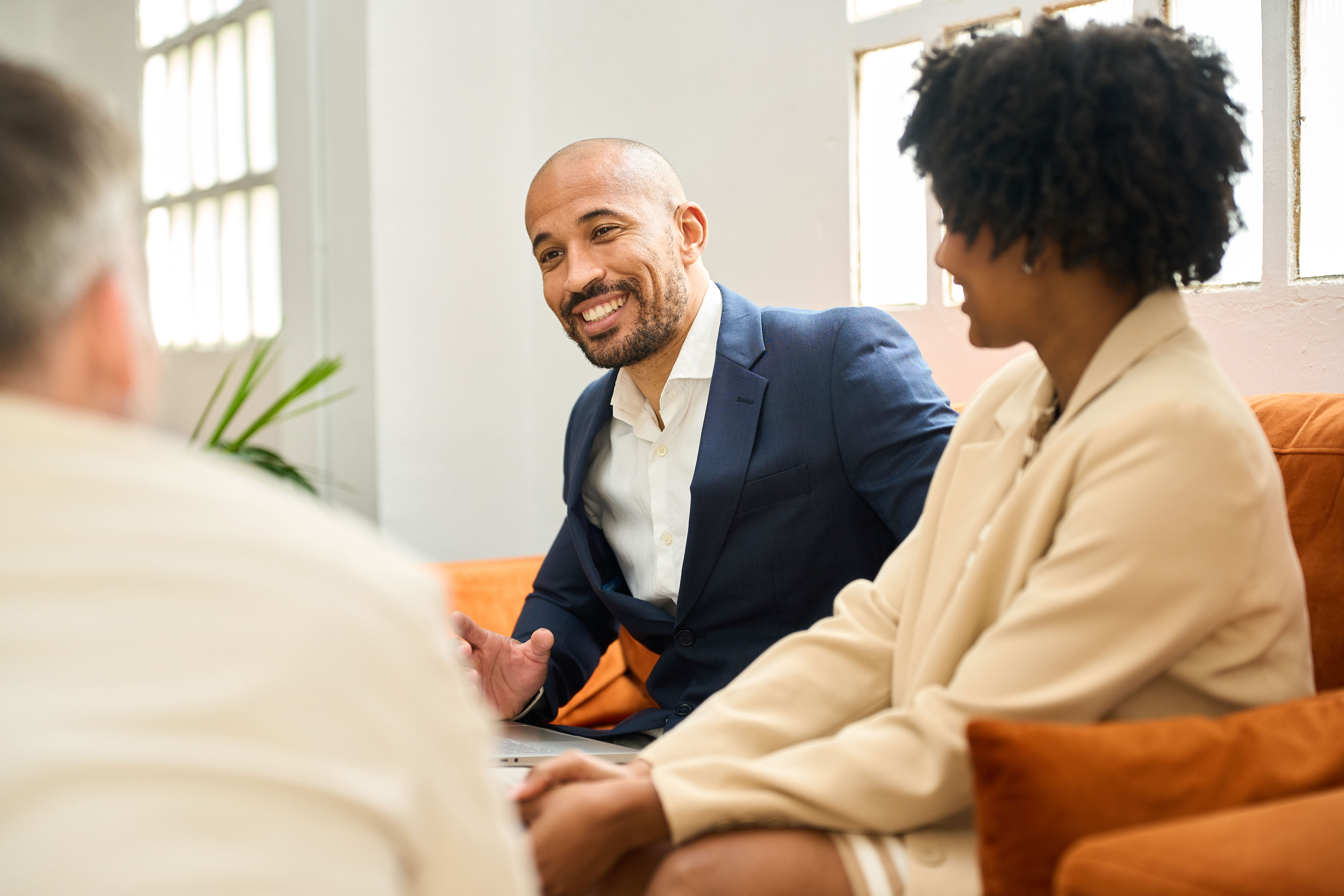 Financial professional meeting with clients to discuss investment strategies.