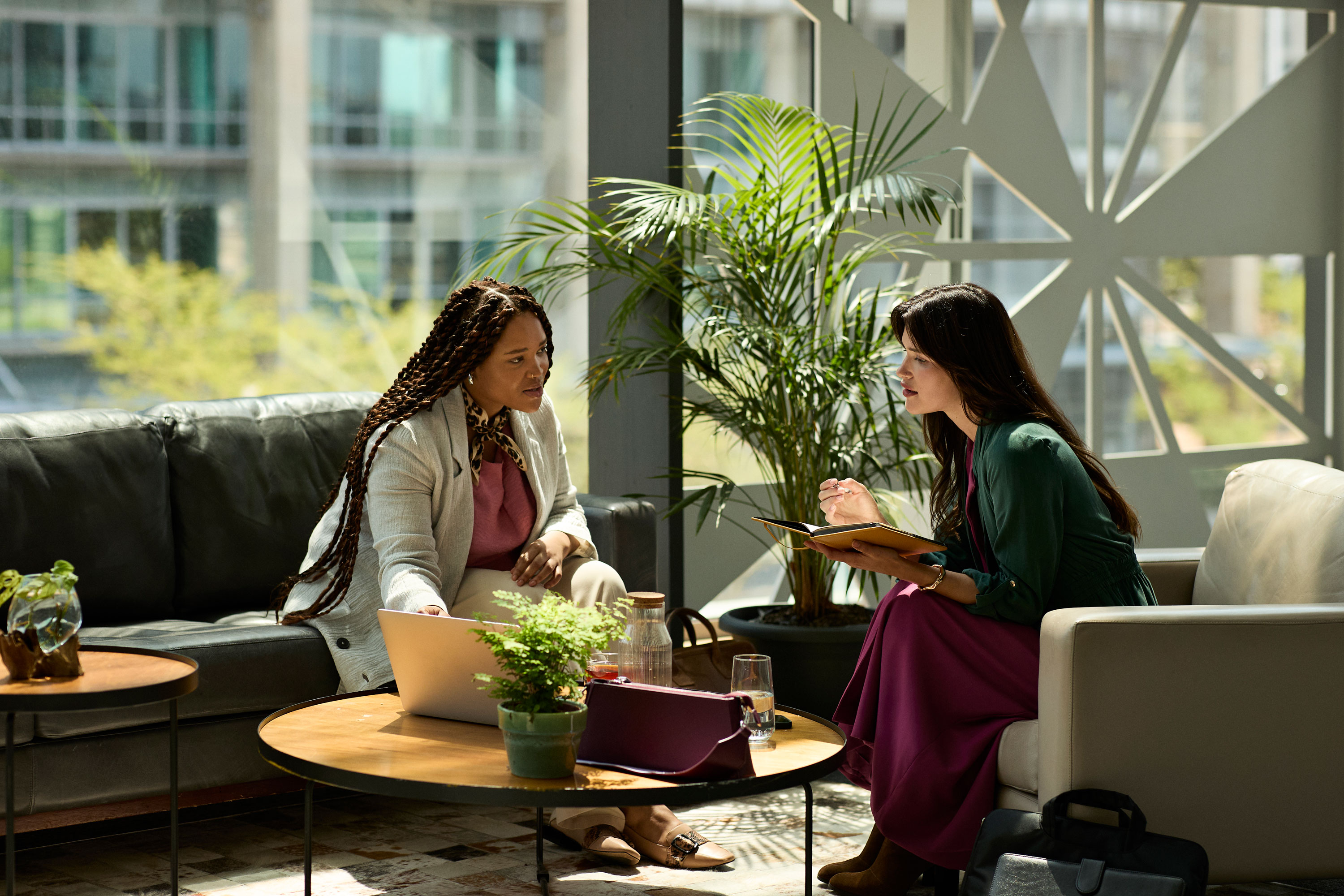 Two women meeting to discuss financial goals and personalized planning strategies in a professional setting.