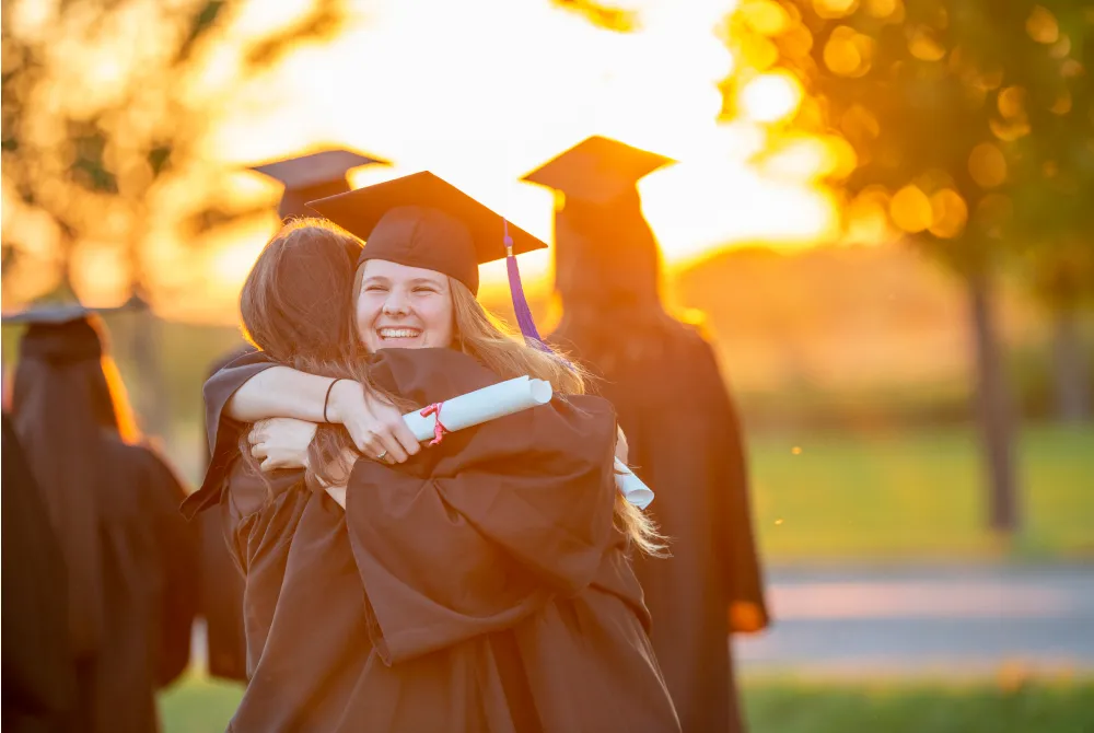 two women hugging at graduation