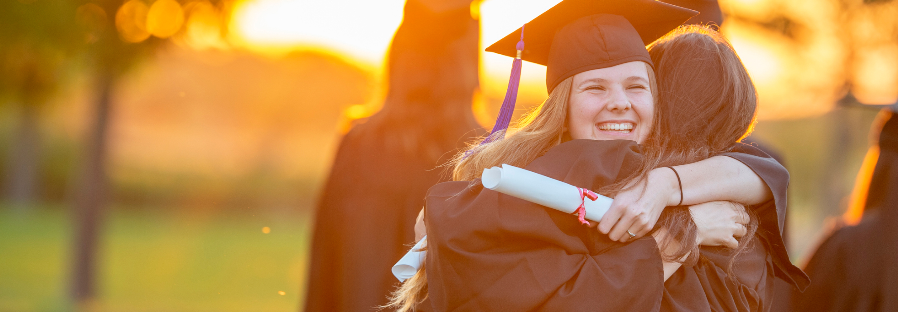 Two women hugging at graduation