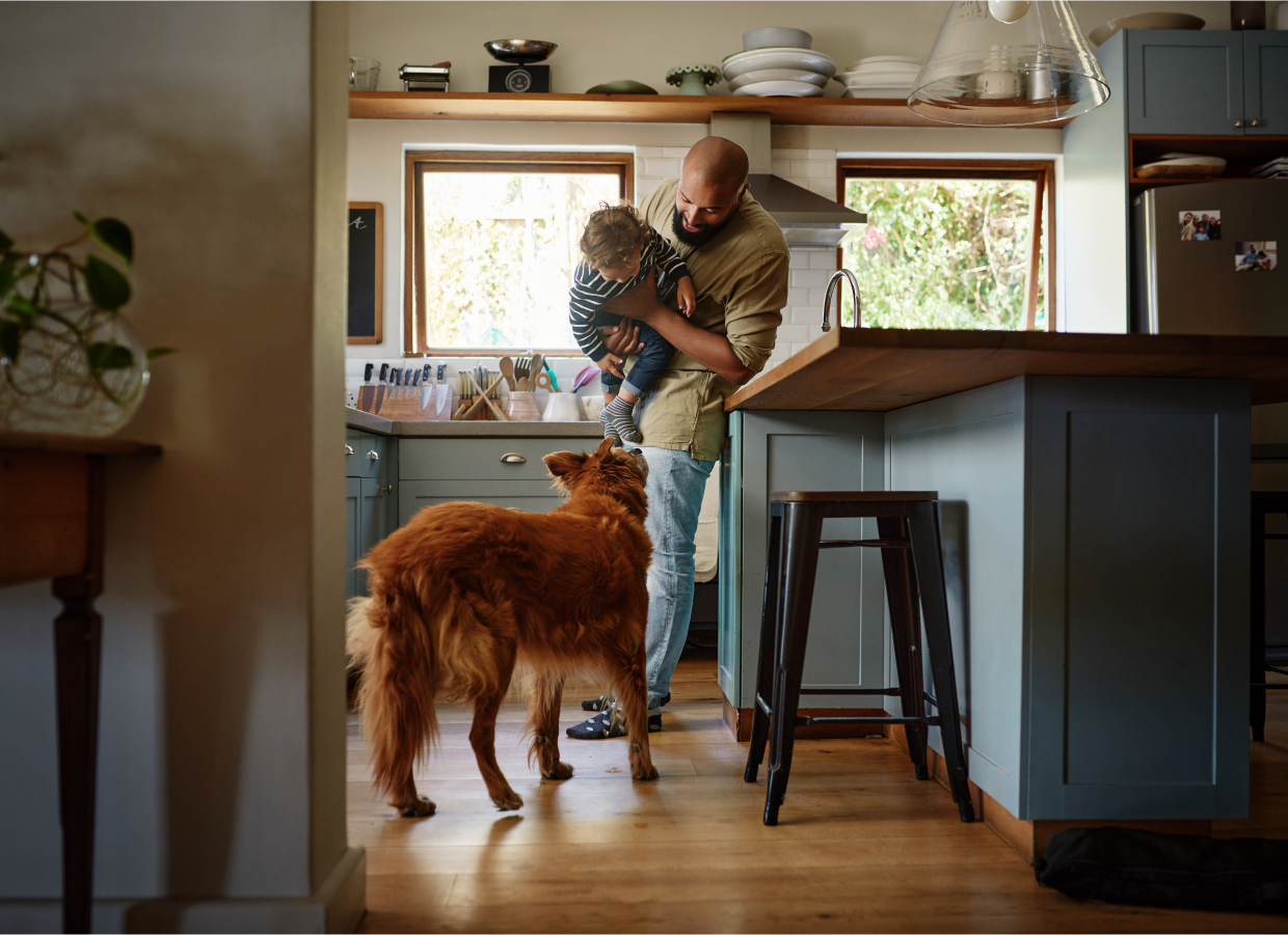 man in his home with young child