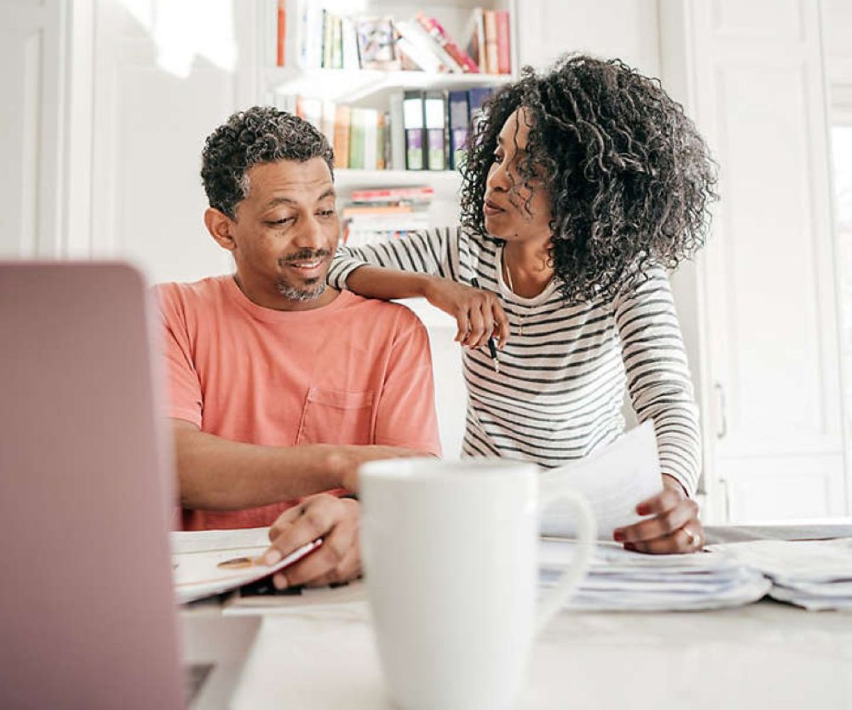 Couple reviewing bills and household finances together at home.