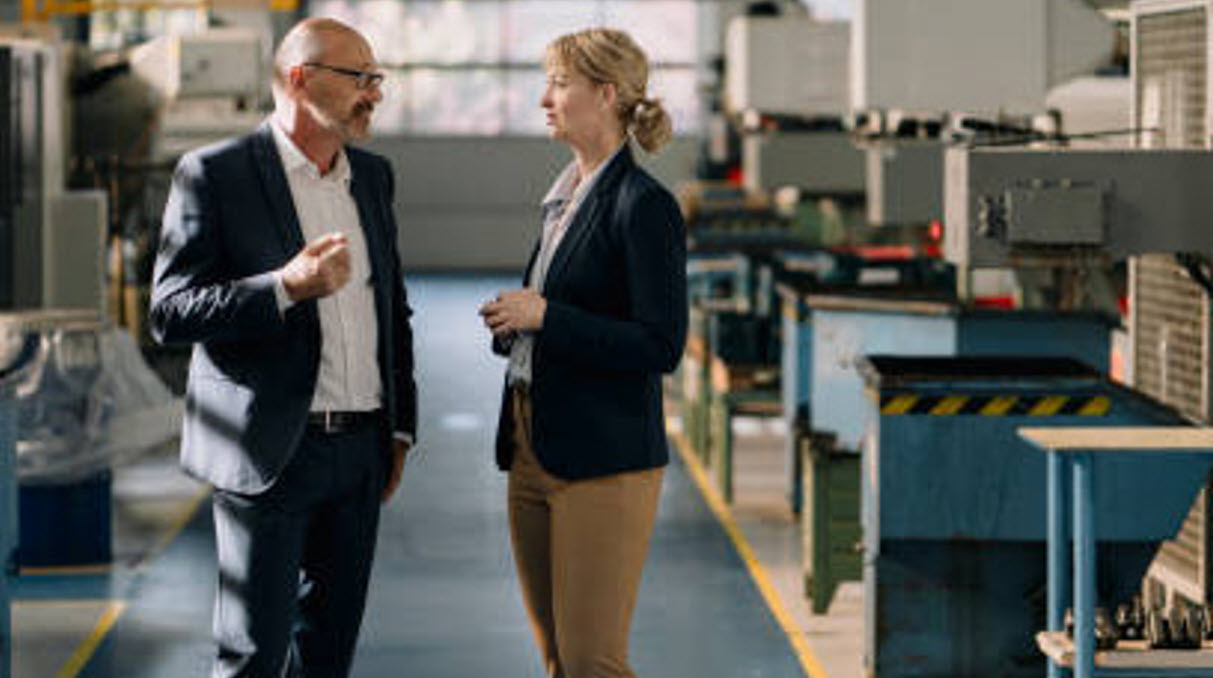 coworkers talking in hallway