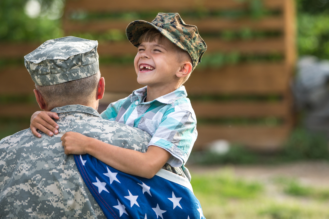 Military man father hugs son​
