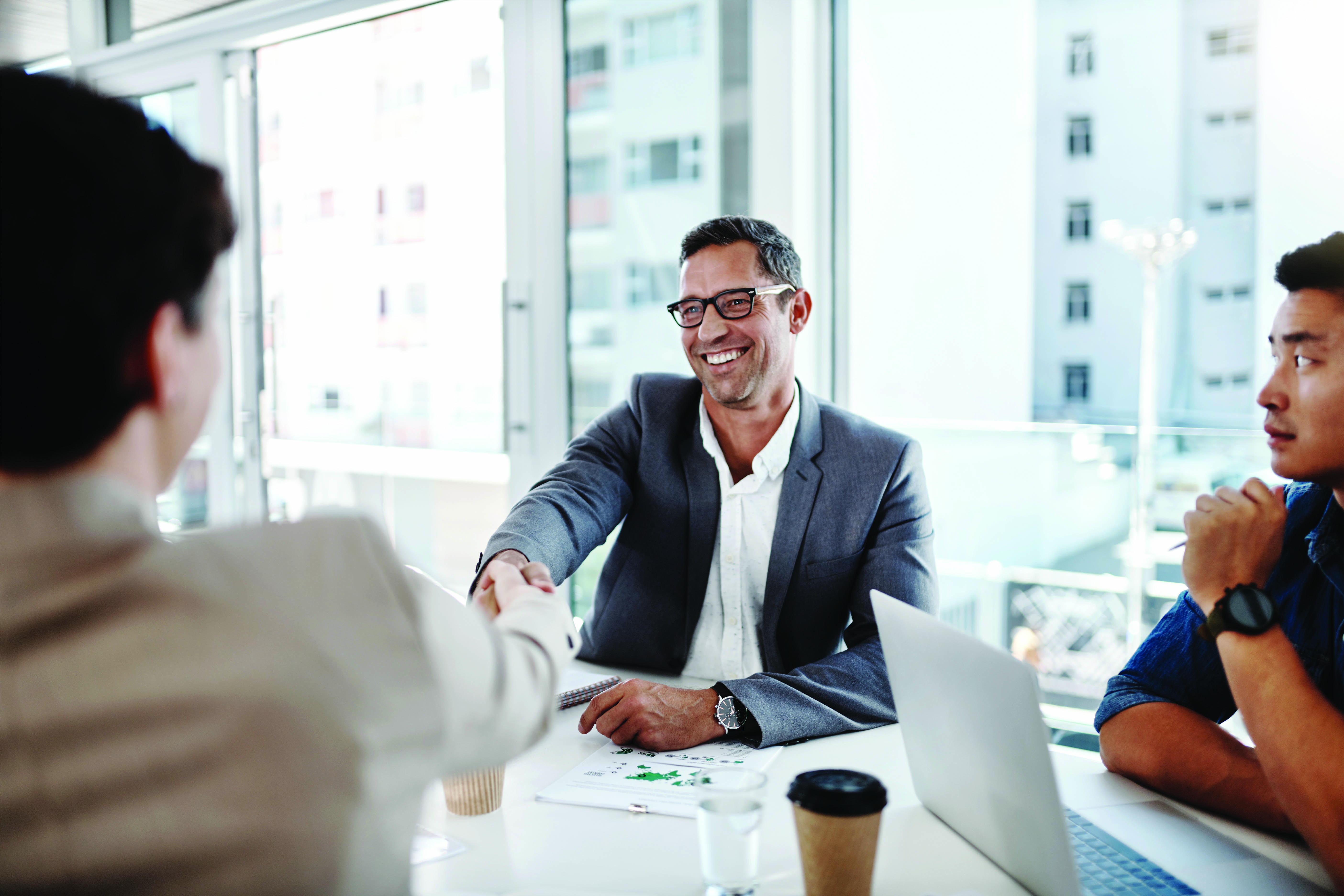 businesspeople shaking hands in an office