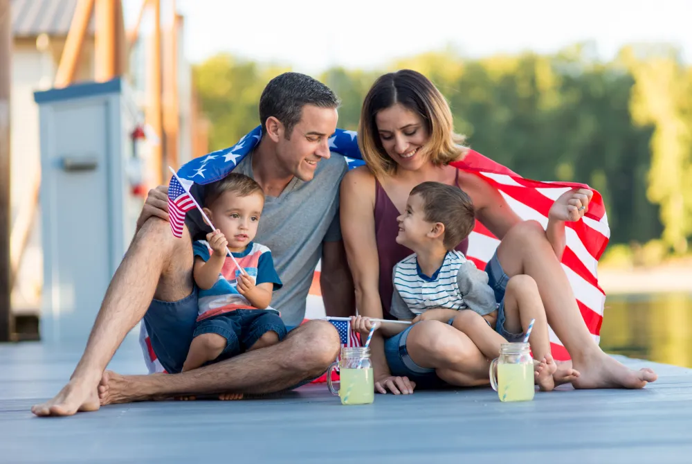 Family of four draped in an American flag 