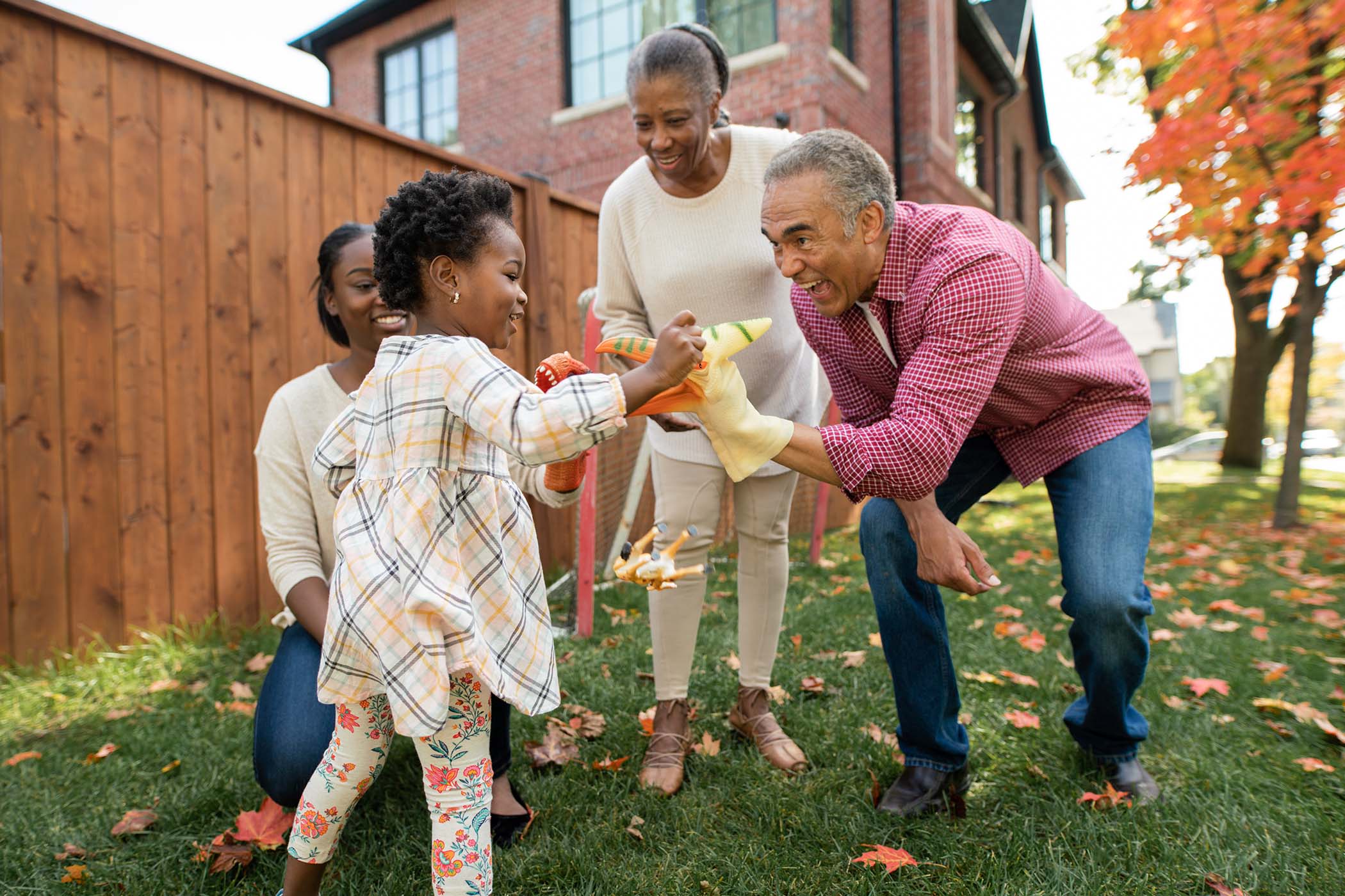 Grandparents, parents, and child spending time together outdoors.