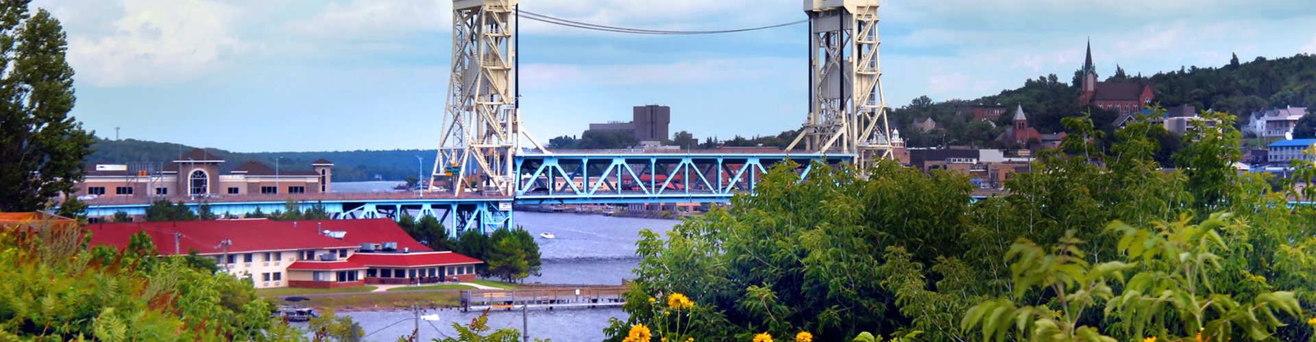 blue bridge stretching across a river