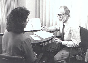 Man reviewing papers with client