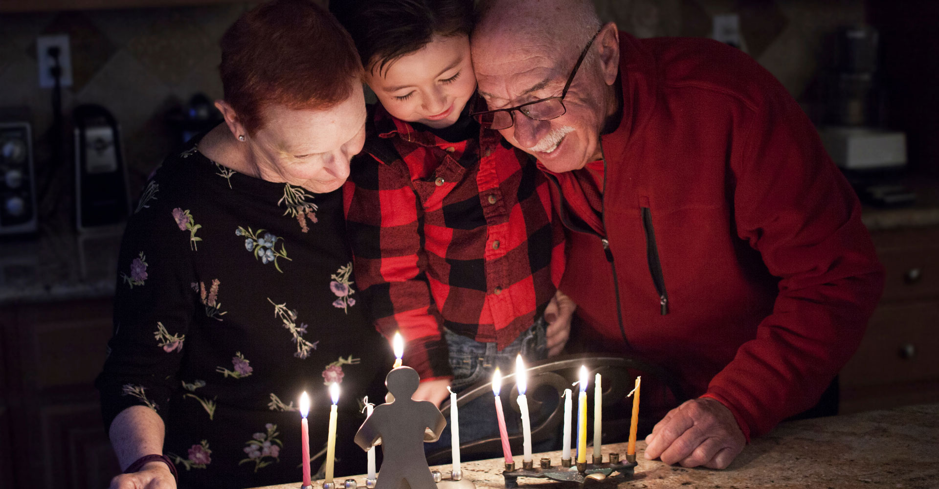 older adults and a child around a birthday cake