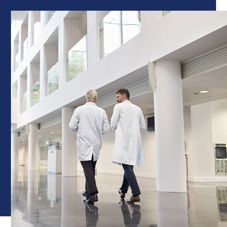 two doctors in lab coats walking together