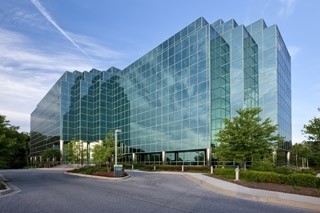 glass office building against a blue sky