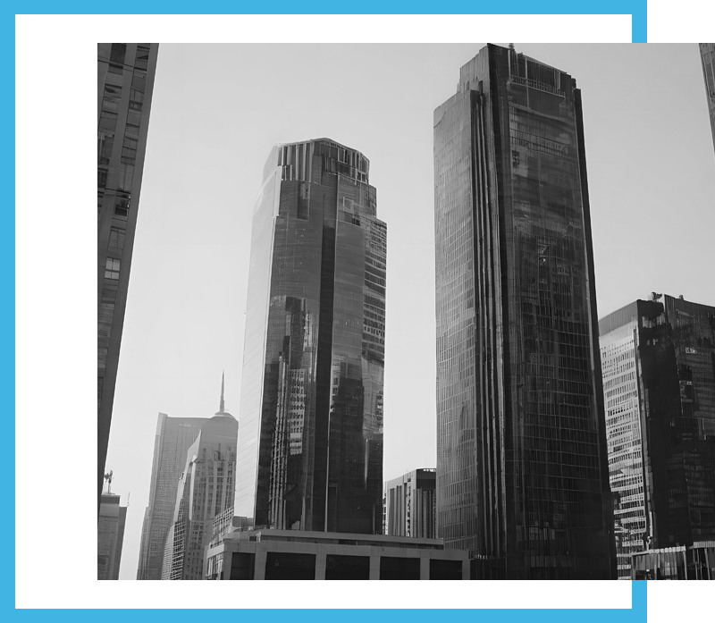 Black and white image of sleek modern skyscrapers framed by a bold blue border against a bright sky.