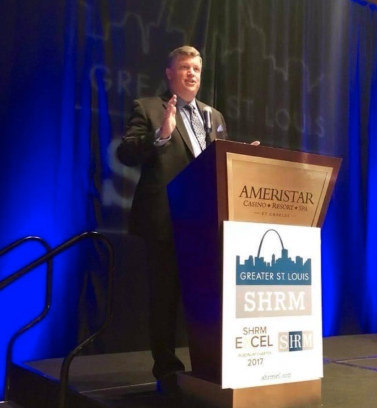Ben Houseman standing at a podium speaking to Greater St. Louis SHRM