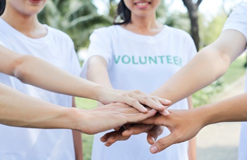 Volunteers standing hands