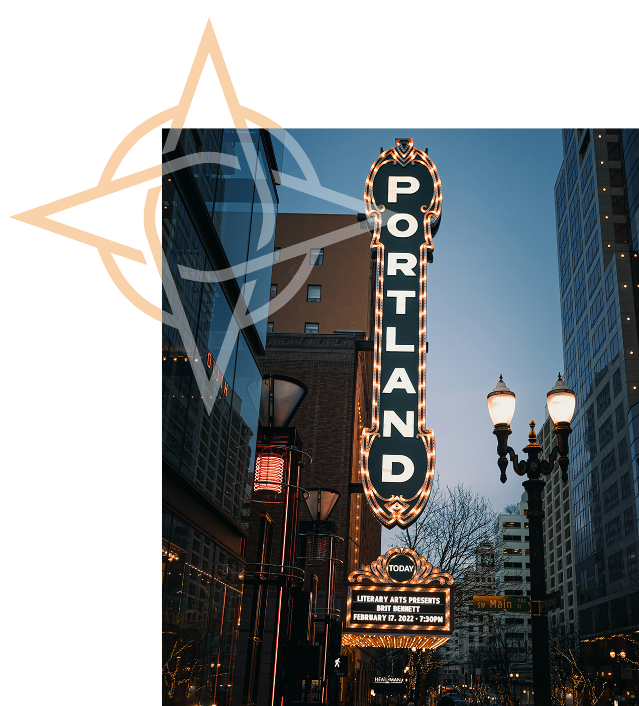 The iconic Portland, Oregon theater sign lit up at dusk on Southwest Broadway and Main Street.