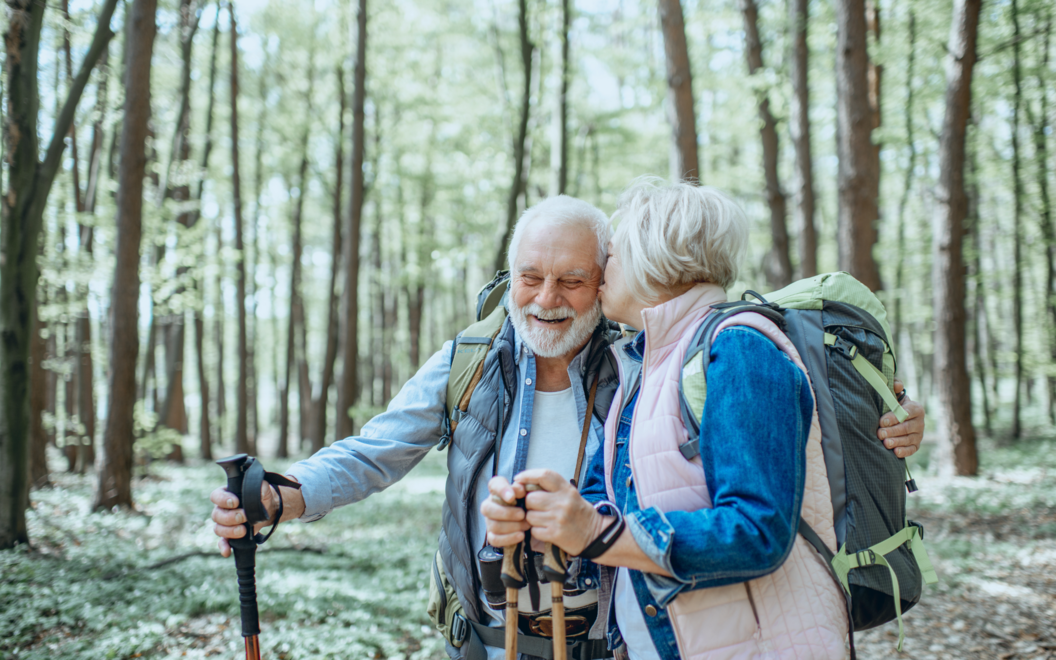 mature couple on a hike in the woods