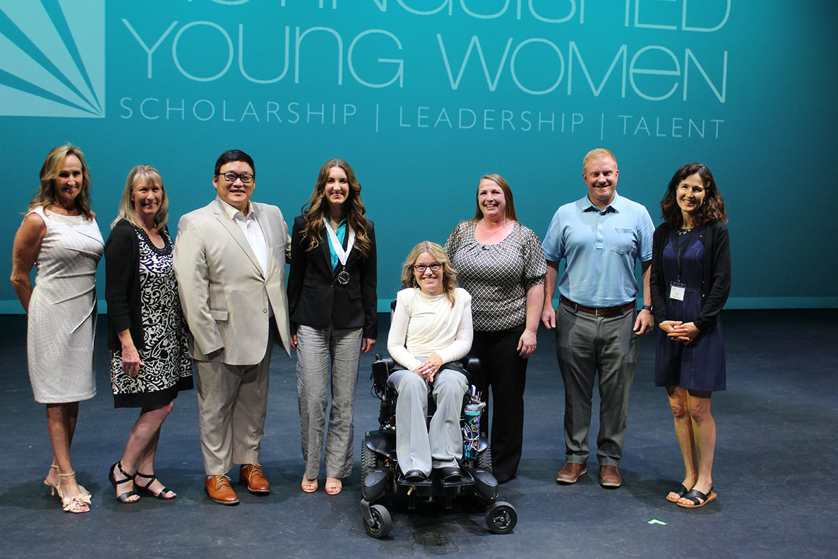 Photo of Chris Grimes with others at the Distinguished Young Women organization 