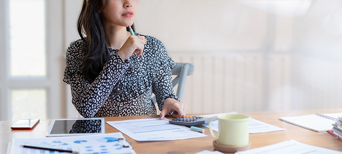 detail woman at table with pen calculator tablet paper bills coffee cup