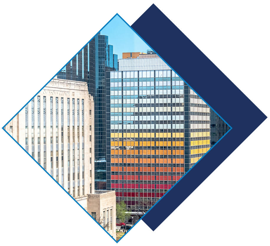 Colorful downtown Oklahoma City high-rise with vibrant striped facade alongside historic buildings