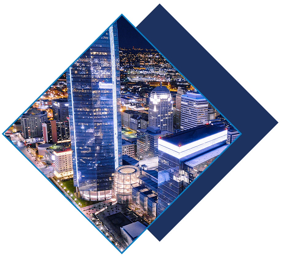 Aerial night view of downtown Oklahoma City with illuminated skyscrapers and city lights