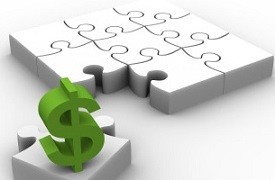 white 3D puzzle with green dollar sign on final piece