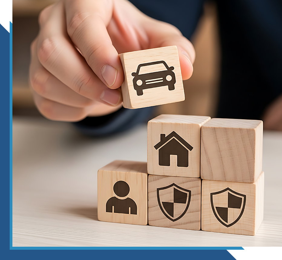 Hand placing a car icon block on stacked cubes representing home, protection, and personal coverage.