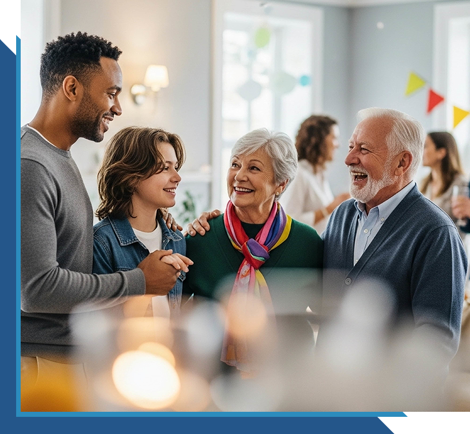 Multi-generational group smiling and talking together in a social setting.