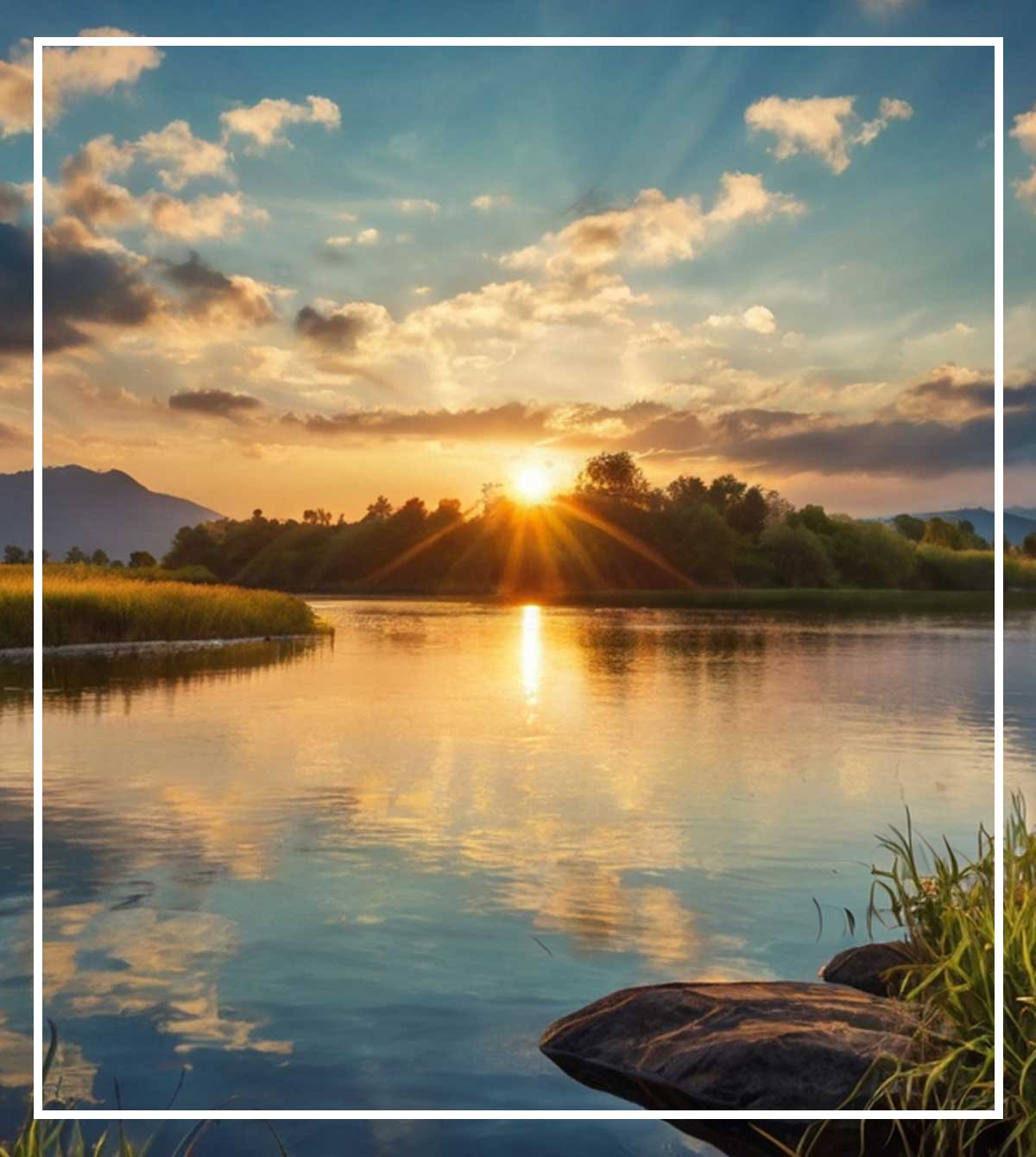 Sun setting over a calm lake with golden light reflecting on the water and trees along the shoreline.