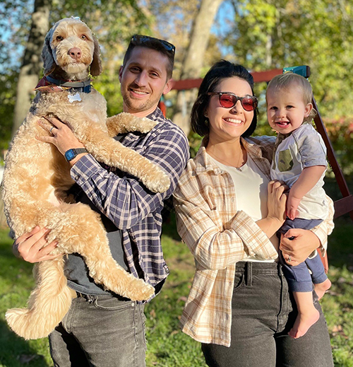Hayward Family Outdoors Holding Dog Image 