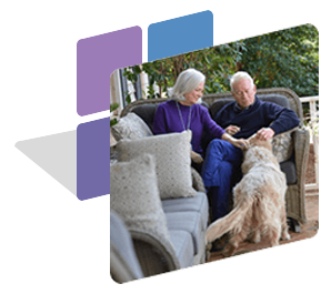couple sitting outside with dog