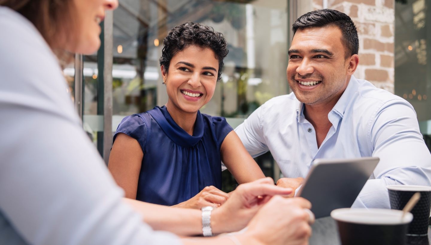 Husband and Wife Meeting With Woman Holding iPad Image