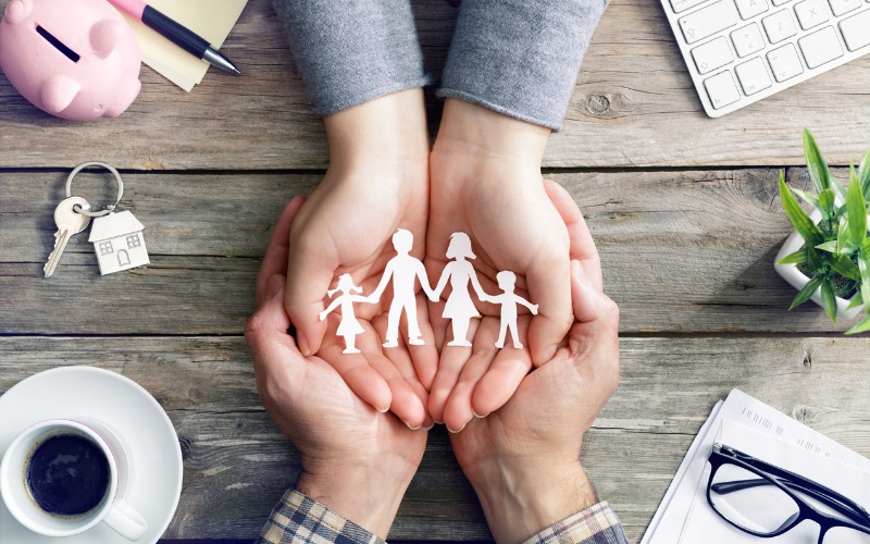Man and Woman's Hands Holding Paper Family Cutout Image