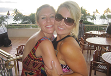 Donna Hugging Blonde Woman in Outdoor Cafe Image