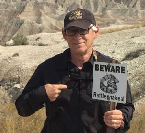 Stuart Holding Beware Rattlesnakes Sign Image