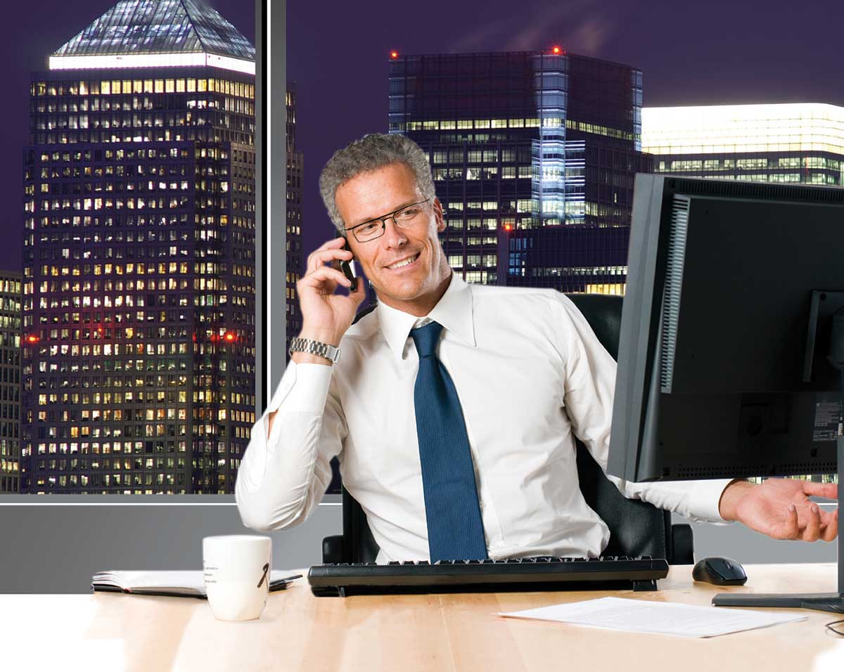 Tom on Phone at Desk With Computer Image