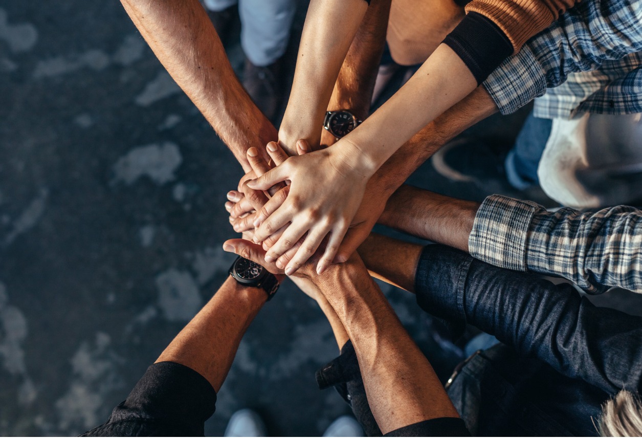 People in a Circle Stacking Hands on Each Other's In a Showing of Teamwork Image
