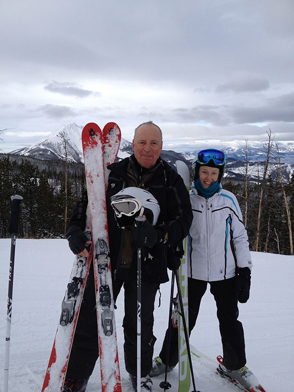 Steve Maus and Boy Atop Mountain Skiing Image