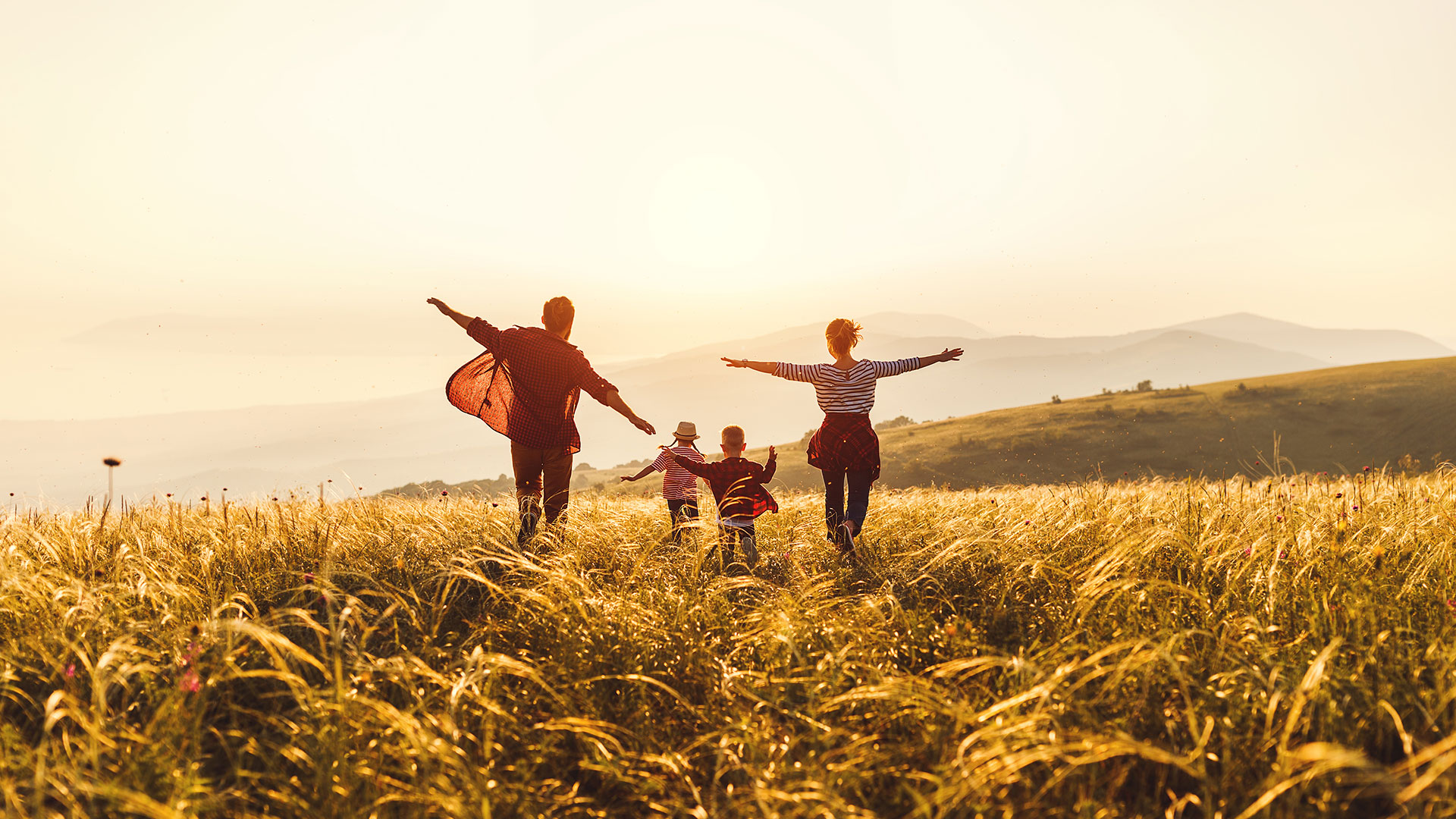Family running through a field