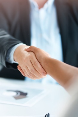 Close up of a man shaking hands with another person