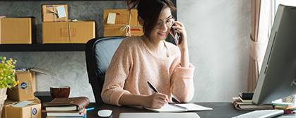 woman at desk talking on phone office environment