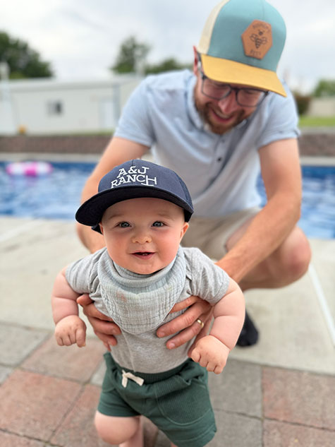 Makena's husband and their son by the pool