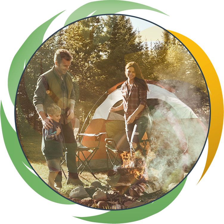Proud of the fire Dad created. a young family camping in the forest.