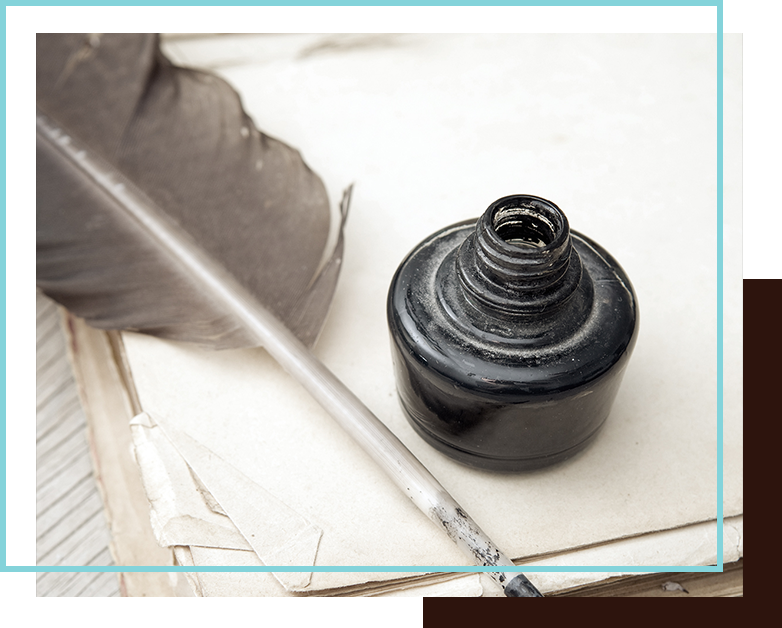 Photo of ink and a feather calligraphy pen