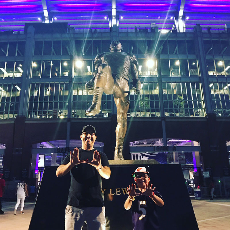 Marc and son in front of arena statue