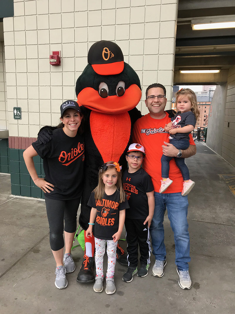 Family posing with Orioles mascot