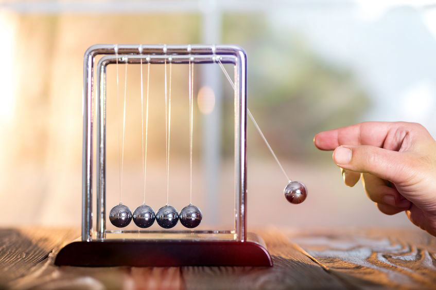 Image of person playing with momentum item