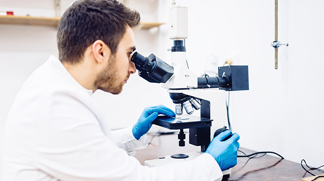 Bio Tech & Pharma > Lab technician at a microscope