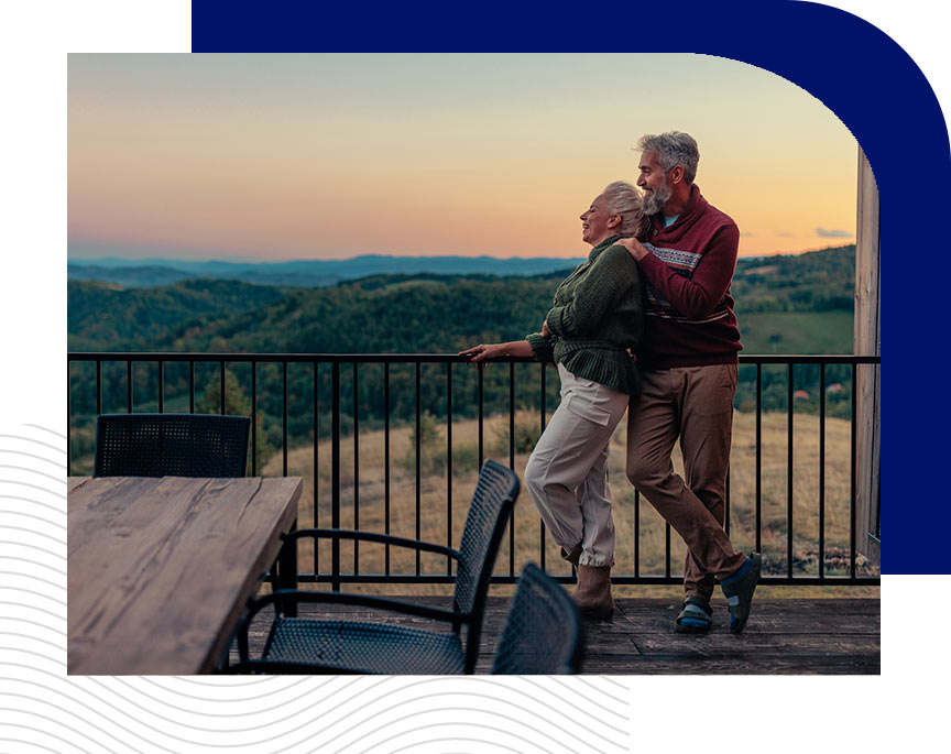 Retired couple enjoying a mountain view on their back patio