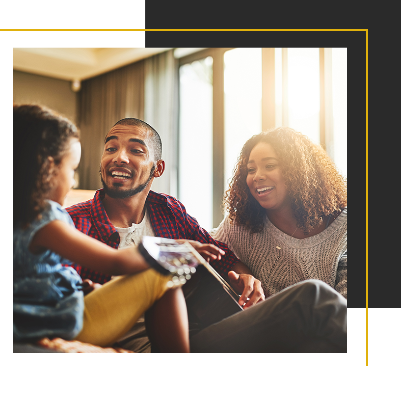 A joyful family shares a relaxed moment at home, laughing together in the warm sunlight